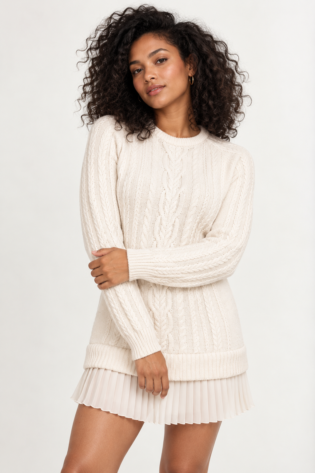 Woman wearing a cable-knit mini dress with a pleated hem in Soft Ivory, front view #F4ECE4