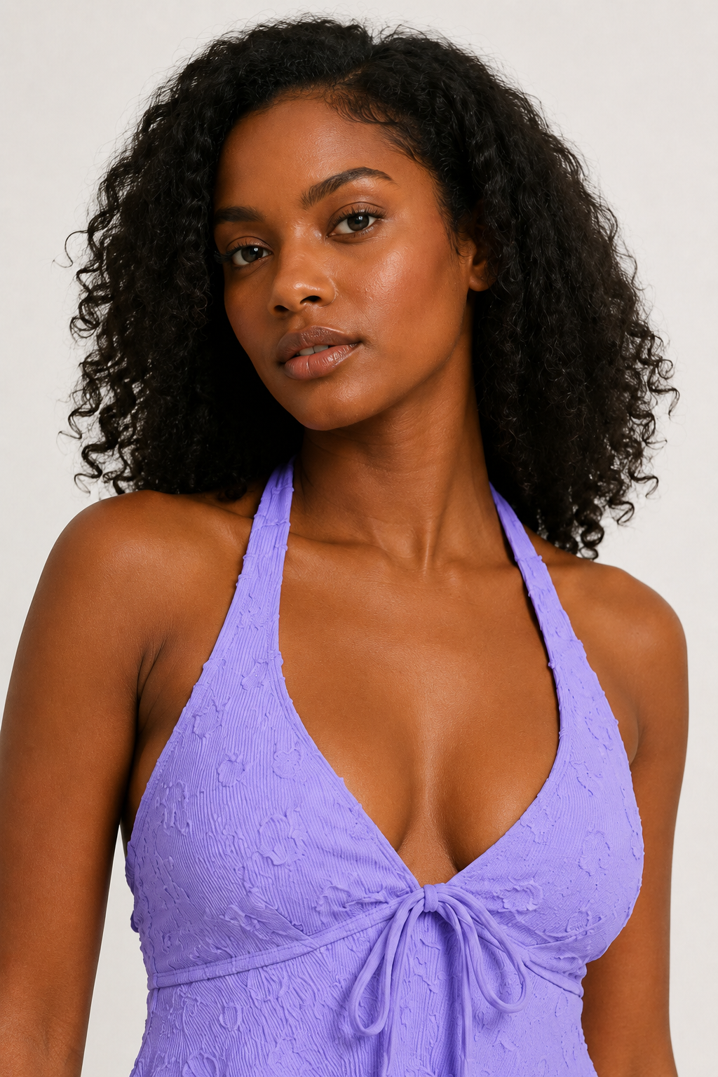 Woman modeling a Wisteria purple tiered ruffle halter tankini swimsuit