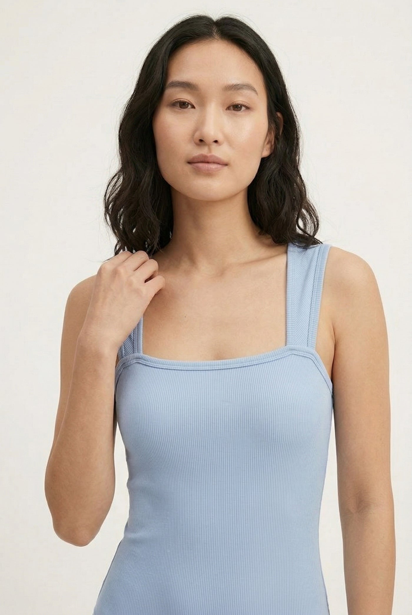 Model wearing an Echo Blue light blue square neck one-piece swimsuit